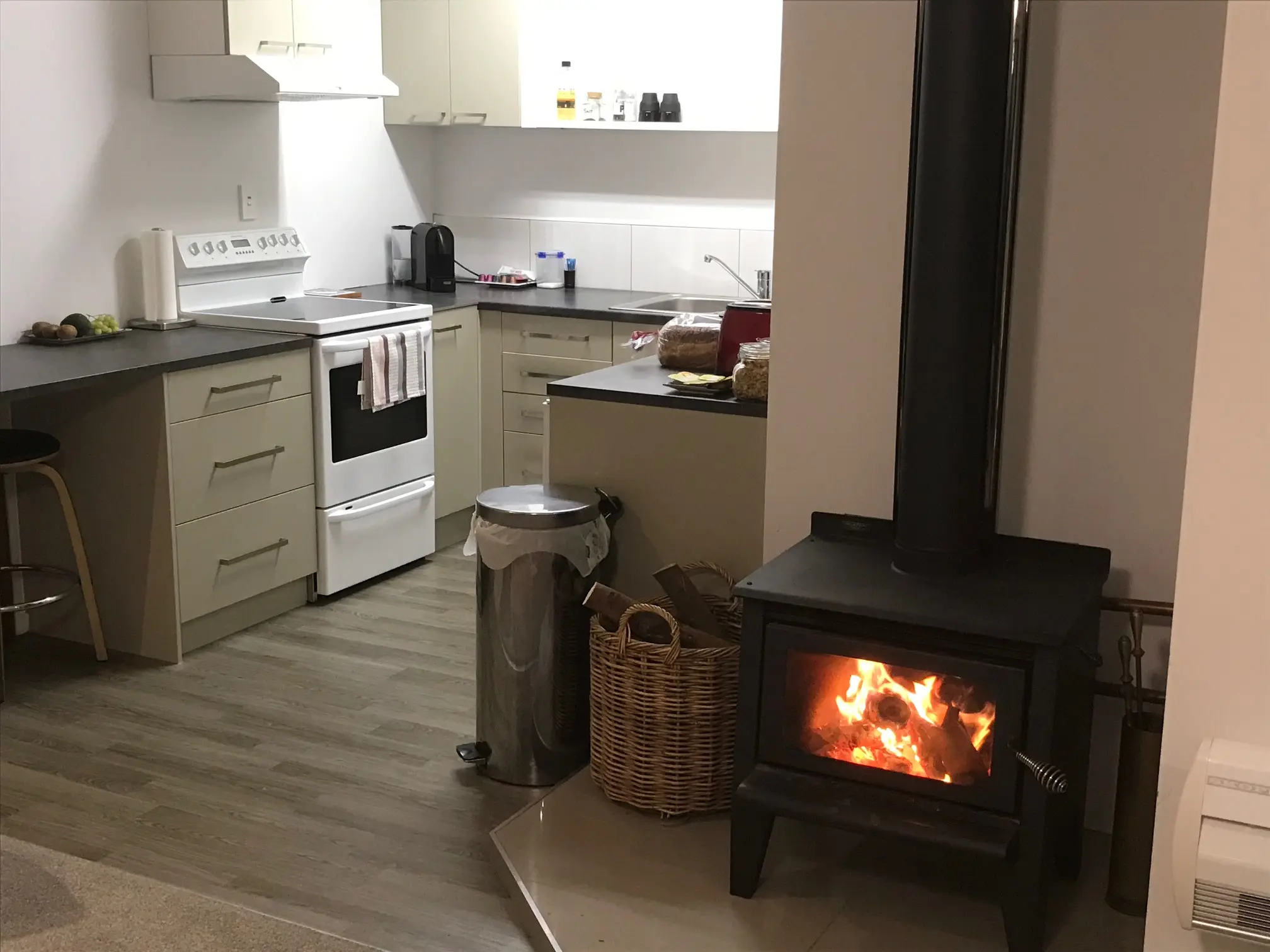Private outdoor patio with dining table, chairs and gas BBQ at Baybell Lodge